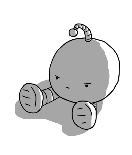 A round robot with banded legs and a drooping antenna sitting on the ground, facing away from the light so it's mostly in shadow. It looks very, very grumpy.