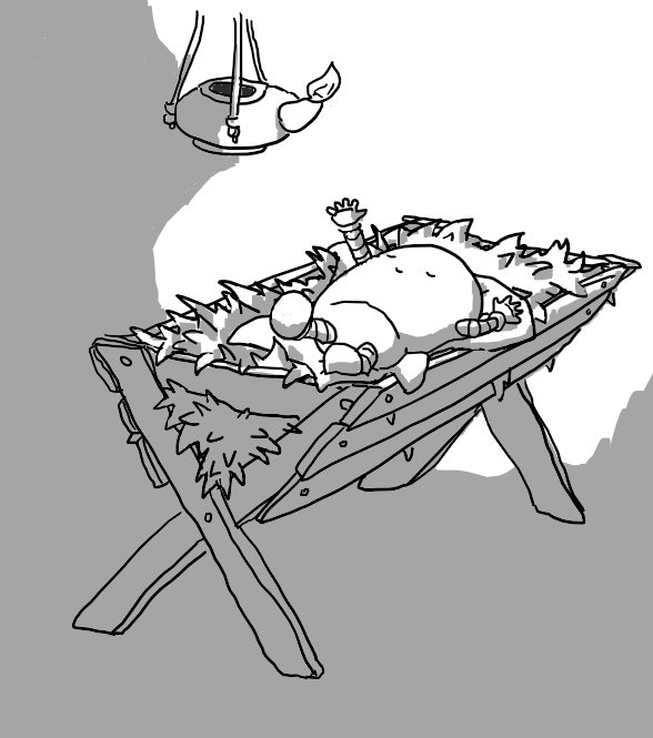 A small, round-topped robot with banded arms and legs sleeps peacefully on a wooden manger filled with straw. It's kicking out with one leg and reaching up towards a clay lamp hanging over it that casts light around the robot.