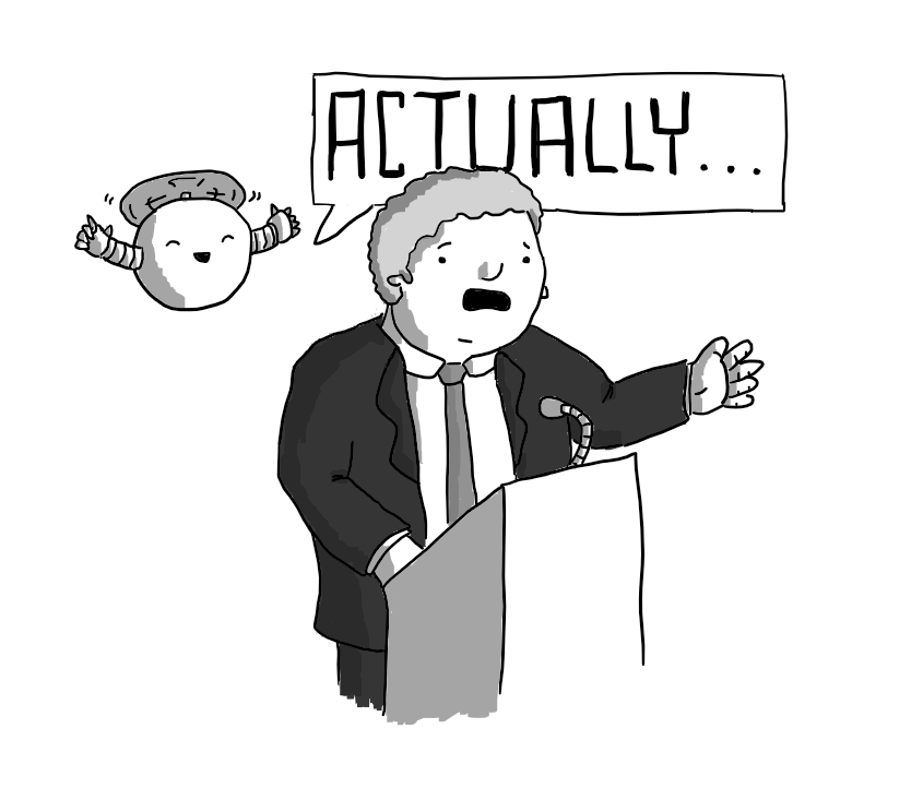 A man in a suit giving a speech at a lectern, looking alarmed as a spherical robot with banded arms and held aloft by a propeller on its top hovers beside it. The robot looks very happy and a large speech bubble is coming from it reading "ACTUALLY..."