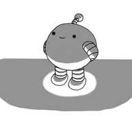 A spherical robot with banded arms and legs and an antenna. It's standing on a darkened surface, with a spotlight emanating from directly below it, such that it causes the robot to be starkly illuminated from beneath. The robot is smiling serenely with its hands behind its back, as if waiting patiently.
