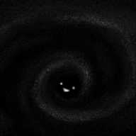A faint, cloudy image depicting a dark spiral that, at its centre, is absolutely black except for a happy little face picked out in white.