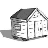 A robot in the form of a wooden garden shed, with a pitched roof and wheels on the bottom. The door is on the gable end and the robot's smiling face is above it, just below the eaves of the roof.