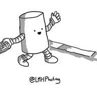 A cheerful cylindrical robot walking down a pavement with a phone in one hand and waving at someone out of frame with the other.