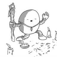 An ovoid robot holding a gnarled wooden staff hung with feathers in one hand, wearing a crystal pendant as a necklace and kneeling with its free hand raised and its eyes closed, mouth open as if speaking. It's surrounded by guttering candles, has a bowl of smoking incense and the floor in front of it is inscribed with arcane symbols.